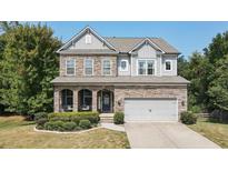Two-story house with stone accents and a landscaped yard at 520 Andes Ln, Canton, GA 30114