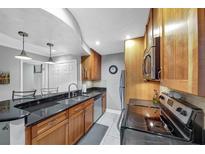 Modern kitchen with stainless steel appliances and granite countertops at 6 Arpege Nw Way, Atlanta, GA 30327