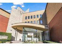 Modern building exterior with glass entryway and landscaping at 401 16Th Nw St # 1381, Atlanta, GA 30363