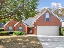 Charming one-story brick home with a manicured front yard and a two-car garage at 202 Meridian Dr, Stockbridge, GA 30281