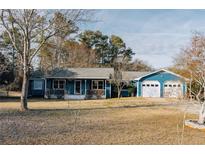 Ranch style home with blue siding, white trim, and a two-car garage at 110 Fox Meadow Dr, Covington, GA 30016