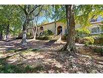 Brick building exterior with lush landscaping and tree-lined walkway at 3236 Henderson Mill Rd # 6, Atlanta, GA 30341