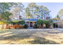 Brick ranch house with a spacious yard and mature trees at 4220 Rickenbacker Ne Way, Atlanta, GA 30342