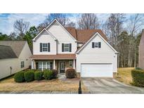 Two-story house with brown roof, beige siding, and a two-car garage at 2725 Sedgeview Way, Buford, GA 30519
