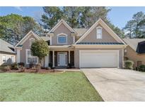 Charming two-story home with stucco exterior, well-manicured lawn, and attached two-car garage at 3850 Laurel Nw Dr, Acworth, GA 30101