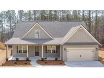 Craftsman style home with gray siding, covered porch, and two-car garage at 8980 Callaway Dr, Winston, GA 30187