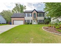 Brick two-story house with attached garage and landscaped lawn at 814 Sunny Field Ln, Lawrenceville, GA 30043