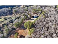 An aerial view of the home and surrounding wooded acreage, showcasing its secluded location and outdoor space at 4320 Center Hill Church Rd, Loganville, GA 30052