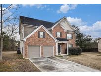 Beautiful two-story brick home with a two car garage, manicured lawn and lovely curb appeal at 436 Margaux Way, Atlanta, GA 30349