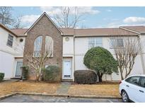 Two-story townhome with brick and siding exterior, landscaping, and parking at 502 Bridge Se Ln, Smyrna, GA 30082