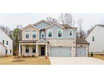 Two-story house with stone and shingle accents, two-car garage, and landscaping at 776 Clifftop Crossing, Powder Springs, GA 30127