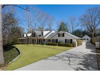 Charming traditional home with a manicured lawn and a long private driveway at 4539 Tall Pines Nw Dr, Atlanta, GA 30327