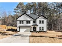 Two-story house with white siding, black accents, and a two-car garage at 400 Stone Lea Trce, Oxford, GA 30054