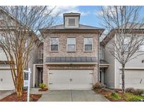 Brick front exterior of a charming townhome with a two-car garage at 2251 W Village Ln, Smyrna, GA 30080