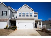 Two-story townhome with gray siding, white garage door, and landscaping at 38 Rocky Knl, Dallas, GA 30157