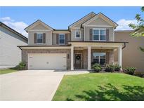 Two-story house with brick and siding, large windows, and a two-car garage at 435 Auburn Crossing Dr, Auburn, GA 30011