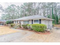 Charming single-story home featuring a brick facade, manicured shrubs, and a well-maintained front yard at 2534 Ben Hill Rd, Atlanta, GA 30344