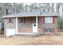 Ranch style home with brick and siding exterior, red shutters, and a covered porch at 6540 Connell Rd, Atlanta, GA 30349