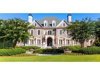 Elegant brick home with landscaped grounds and three-car garage at 4000 Heatherwood Way, Roswell, GA 30075