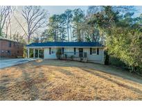 Charming single-story home with a covered carport and a well-maintained front yard at 1927 Cindy Dr, Decatur, GA 30032