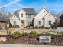 Two-story home with white brick, gray shutters, and landscaping at 1782 Patrick Rd, Dacula, GA 30019