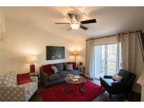 Bright living room with hardwood floors, fireplace, and balcony access at 547 Granville Ct, Atlanta, GA 30328