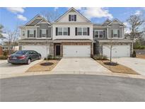 Three-unit townhome building with attached garages and landscaping at 5857 Silver Lake Dr, Mableton, GA 30126