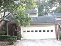 Two-story brick home featuring a two-car garage with multi-paneled doors and a covered entrance at 5 Belmonte Sw Ct, Atlanta, GA 30311