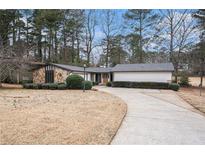 Ranch style home with stone accents and a large driveway at 776 Sugar Creek Se Trl, Conyers, GA 30094