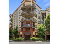 Brick building with multiple balconies and landscaped grounds at 200 River Vista Dr # 606, Atlanta, GA 30339
