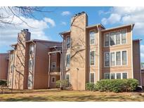 Exterior of a multi-Gathering home with a flat, grassy front yard and mature landscaping at 1525 Terrell Mill Se Pl # A, Marietta, GA 30067