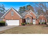 Brick house with a two-car garage and manicured lawn at 3155 Wellbrook Dr, Loganville, GA 30052