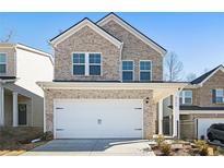 Charming two-story brick home with a two-car garage and well-maintained landscaping at 4722 Blake Loop, Atlanta, GA 30349