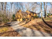 Attractive home nestled on a wooded lot with a long driveway at 650 Old Orchard Sw Dr, Marietta, GA 30064