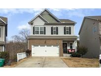 Two-story brick home with a white garage door and a landscaped yard at 135 Cessna Dr, Canton, GA 30114