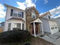 Charming two-story home with stone accents and a well-maintained front yard at 6383 Phillips Ct, Lithonia, GA 30058