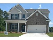 Charming two-story home featuring a brick facade, a two-car garage, and a welcoming front porch with white columns at 480 Paces Dr, Lithia Springs, GA 30122
