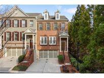 Charming brick townhome with manicured front yard, two car garage, and inviting entrance at 3261 Ferncliff Ln, Atlanta, GA 30324