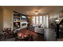 Spacious living room featuring a fireplace, built-in shelving, and hardwood floors at 2511 High Brow St # 43, Duluth, GA 30096