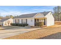 Ranch style home with a spacious yard and driveway at 3367 Lineview Dr, Ellenwood, GA 30294