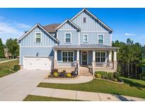 Two-story light blue house with a metal roof, brick accents, and a large front porch at 1553 Brunswick St, Lithia Springs, GA 30122