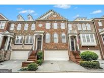 Brick front of charming townhome with attached two-car garage at 5104 Leeshire Se Trl # 64, Atlanta, GA 30339