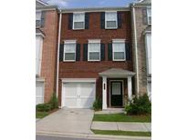 Charming brick townhome with attached garage and covered entryway at 2192 Landing Walk Dr, Duluth, GA 30097