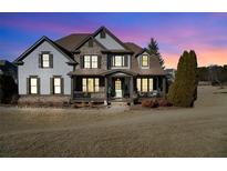 Two-story house with stone and shingle accents, and a wrap-around porch at 6610 Wesley Trail Holw, Cumming, GA 30028