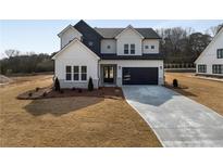 Two-story farmhouse with gray siding, black accents, and a long driveway at 4265 Haynes Cir, Snellville, GA 30039