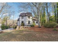 Charming two-story home featuring a well-maintained lawn and mature trees, providing curb appeal and a sense of tranquility at 3536 Evans Ridge Trl, Atlanta, GA 30340