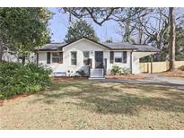 Charming brick home featuring a well-maintained front yard and covered carport at 2848 Monticello Pl, Decatur, GA 30030