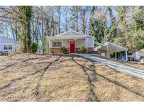 Charming single-story home with a red front door and cozy carport at 2720 Santa Barbara Nw Dr, Atlanta, GA 30318