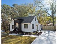 White and black charming house with landscaped lawn and driveway at 2442 Connally Dr, Atlanta, GA 30344