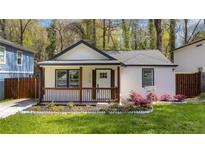 Charming cottage with white exterior, brown trim, and a well-manicured lawn at 1318 Graymont Sw Dr, Atlanta, GA 30310